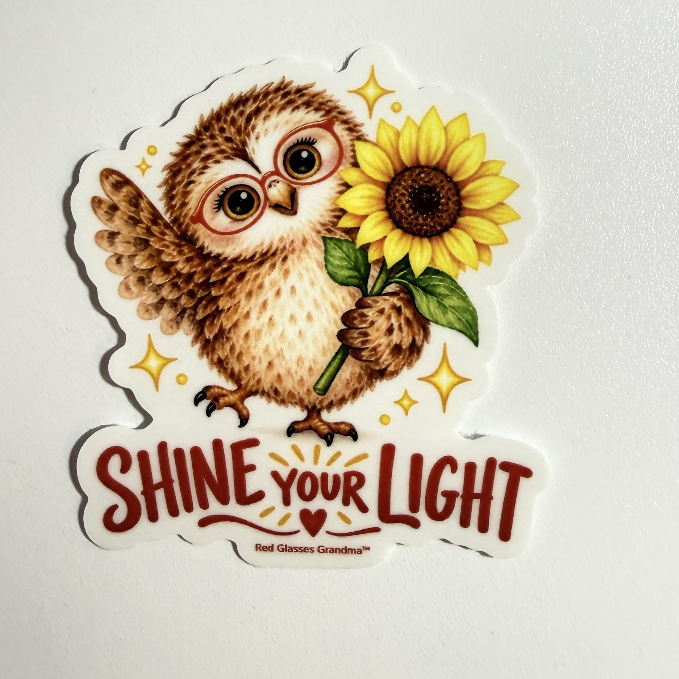 Shine Your Light owl sticker, with a friendly owl holding a sunflower