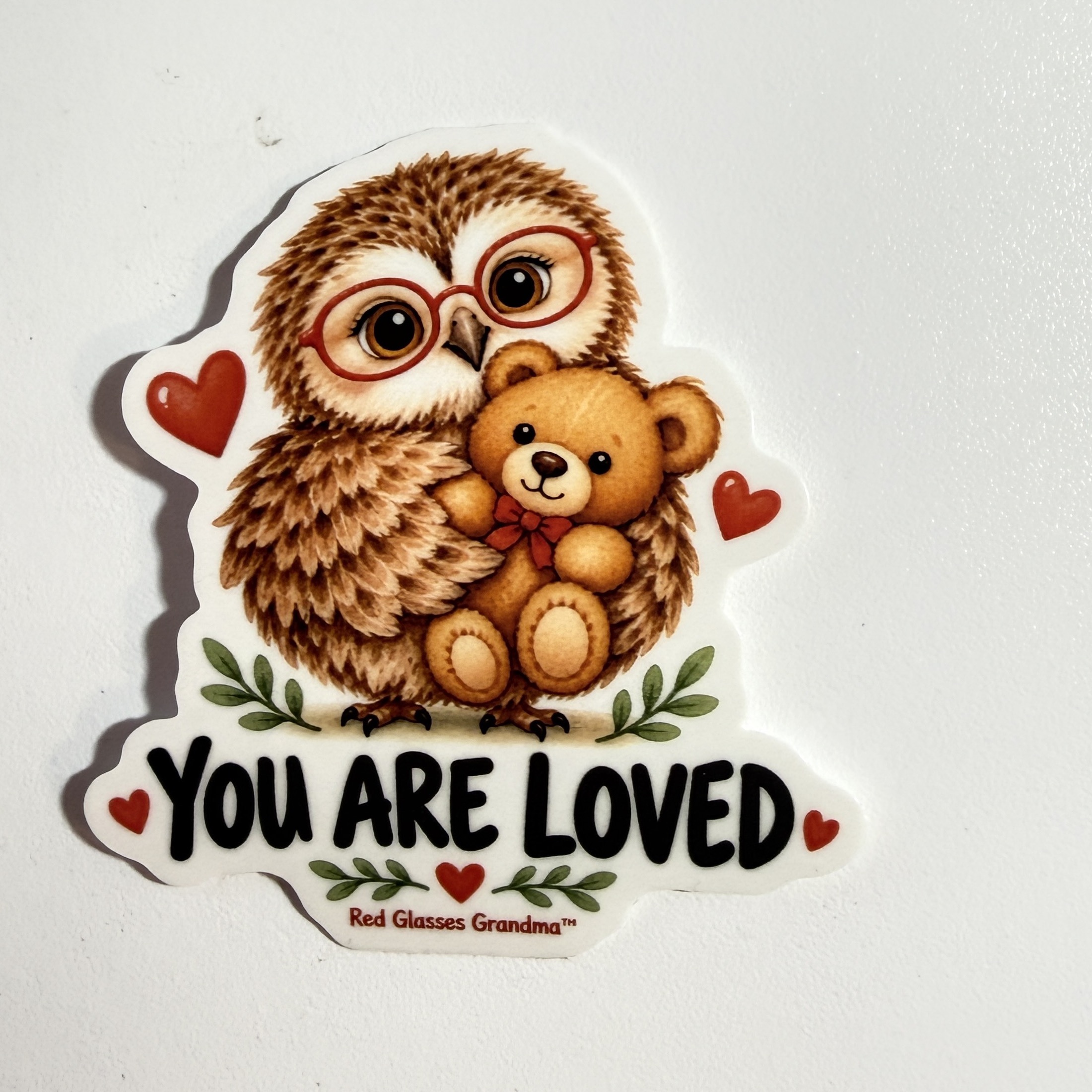 You Are Loved owl sticker, with a friendly owl holding a teddy bear
